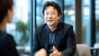 © Topuria Design - Asian businessman engages in a conversation with a colleague, exchanging ideas in a contemporary office setting. Japanese businessman discusses strategy with a colleague in a modern office.