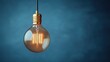 © arsyi_06 - A glowing vintage light bulb hangs against a dark blue backdrop, illuminating the space with a warm, soft light.