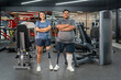 © Verin - portrait persons with prosthetic leg standing arms crossed in gym fitness club