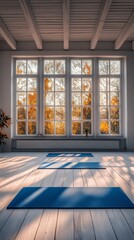 Wall Mural - A tranquil yoga studio with blue mats and large windows overlooking autumn trees