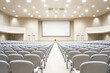 © Konstiantyn Zapylaie - Modern conference hall with rows of empty seats and large screen