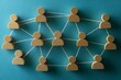 © Imagentive - Wooden People Figures Interconnected by String on Blue Background