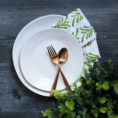 place setting on grey table with copper silverware