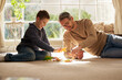 © peopleimages.com - Father, son and play with toys at house for plastic dinosaur, learning and fantasy games of animal education. Smile, family and reptiles with creative development, bonding together and childhood fun