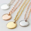 © Mariela - 3 small smooth shiny disc necklaces, one gold, one silver and one rose gold, with matching chains.