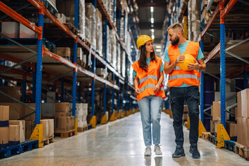 Warehouse workers walking and talking logistics