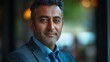 © GRACE - Middle-aged Indian man with a business suit and a friendly look.