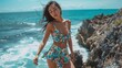 © Pat J. - Asian woman in a stylish one-piece standing on a rocky outcrop with the sea behind her