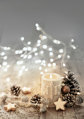 Wall Mural - white christmas candle on rustic wooden boards - decoration with natural elements, twigs, pine cones