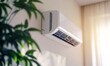 © Valentyna - Modern ductless heat pump system installed on a wall, efficiently regulating room temperature with sleek and compact design in a contemporary home interior
