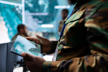 Poster - High tech military office with soldiers analyzing real time data, processing intelligence information and coordinating strategic operations to support military missions effectively.