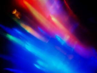 Wall Mural - a colorful, blurry background with a rainbow of colors. the colors are bright and vibrant, creating 