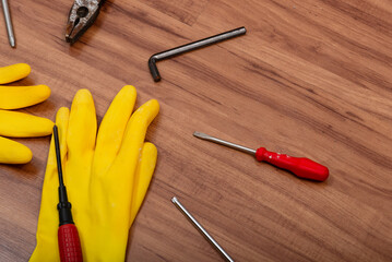 Pair of cleaning gloves, pliers, screwdriver, wrench and other tools