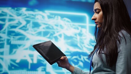 Programmer using tablet to maintenance artificial intelligence neural networks. Close up shot of computer scientist using AI system aiding in processing and transmitting information, camera B