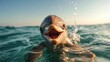 © Dulemegapixel - A joyful dolphin swims towards the camera with water splashes around, capturing the playful and free spirit of marine life in the vastness of the ocean.