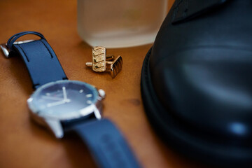 Elegant Accessories: A Close-Up of a Stylish Watch, Cufflinks, and Shoe