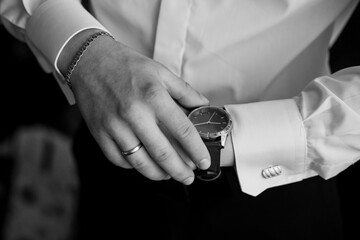 Elegant Groom Adjusting Watch in Formal Attire