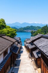 Wall Mural - Scenic view of traditional houses overlooking a serene lake and mountains.