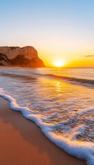 Wall Mural - Sunset over a serene beach with gentle waves and cliffs in the background.