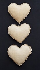 Poster - Three heart-shaped cushions with lace trim on a dark background.