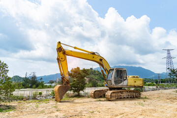 Heavy earth mover with blue sky in the background