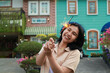 © M Alfan Setyawan - new year eve celebration concept. attractive asian young woman holding sparkler with laughing happy in outdoor garden of vintage house yard