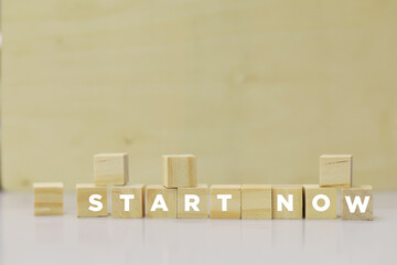 START NOW - Business concept word on wooden puzzle