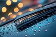 © Maryna - Car Wiper Blades. Close-up of Wipers on Windshield of Modern Vehicle with Raindrops