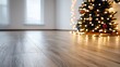 © mjpilot - Empty wooden floor with blurred Christmas tree and lights in the background.