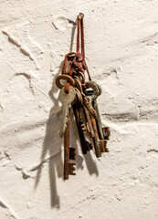 Wall Mural - A bunch of keys hanging from a wall