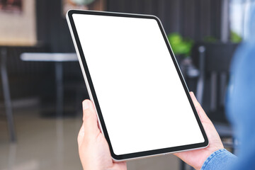 Mockup image of a woman holding digital tablet with blank desktop screen in cafe