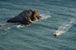 © sablinstanislav - Black sea coast. Little boat in the sea near rock cliff.