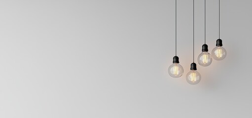 Vintage light bulbs hanging on a grey background with copy space. This creative idea represents the concept of creativity and innovation in business