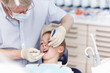 © peopleimages.com - Man, dentist and child with tools for consultation, teeth whitening and oral inspection of dental hygiene. Mature, orthodontics and boy with cleaning procedure, mouth assessment and braces treatment