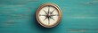 © Dirty Pure - Vintage Compass on Teal Wooden Background, Finding Direction and Purpose