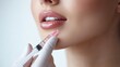 © Anat art - A skilled professional administers a hyaluronic acid injection to enhance the woman's lips and rejuvenate her skin for a youthful appearance. Generative AI