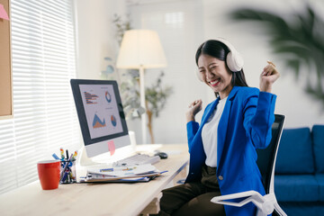 Poster - Happy businesswoman celebrates project completion by dancing and listening to music at her desk in a modern office