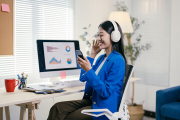 Poster - Businesswoman is working at her desk while listening to music with headphones, enjoying a moment of relaxation during her workday
