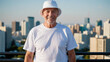 © QuoDesign - Senior man wearing white t-shirt and white bucket hat standing on cityscape background