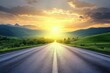 © kribbox - A long, straight asphalt road stretches into the distance with a bright sunset in the background and green hills on either side.