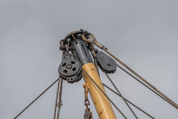 steel mast of a beam trawl where the steel pulleys with steel cables are clearly visible