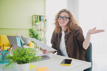 Photo of charming cute girl wear shirt sit table doing homework study from home indoors workplace workspace