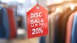 © sadewotito - Red Discount Tag Hanging in a Clothing Store