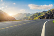 © ABCDstock - Asphalt road and green mountain with sky clouds natural landscape at sunset. road trip.