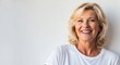 © Arceli - blonde mature woman white background wearing plain white tshirt smiling happy portrait