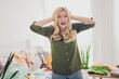 © deagreez - Photo of stressed depressed woman relocation rent new apartment flat mess clothes in living room indoors