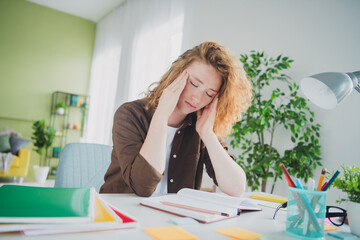 Photo of exhausted unhappy lovely girl wear shirt sit table remote education from home indoors workplace workspace