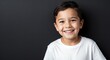 © Arceli - caucasian kid boy black background wearing plain white tshirt smiling happy portrait