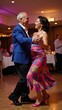 © Pixel Matrix - Senior African-American couple enjoying a fun night out while dancing Salsa together at a social gathering