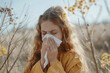 © Tacca Terra - Sneezing girl suffering from seasonal allergy in spring. Caucasian teenager having a cold, blowing her nose.